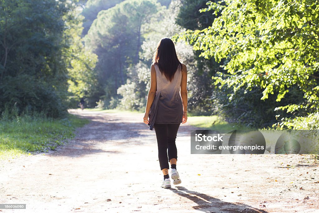 girl walking on a forest trail Active Lifestyle Stock Photo