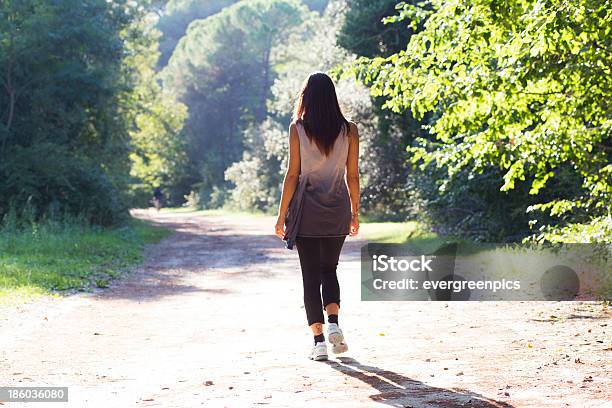 Girl Walking On A Forest Trail Stock Photo - Download Image Now - Active Lifestyle, Activity, Adult