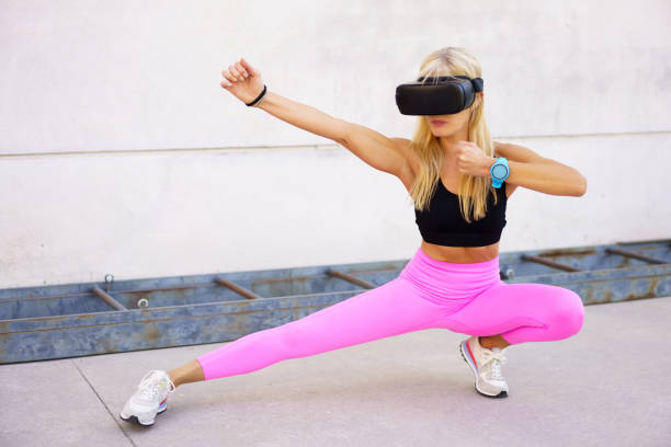 istock Strong sportswoman practicing martial arts in VR headset 1860380978