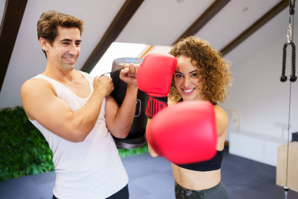 istock Cheerful sportswoman doing boxing stance in gym 1860384593
