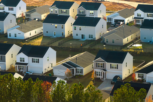 Aerial view of tightly located new family houses in South Carolina suburban area. Real estate development in american suburbs.