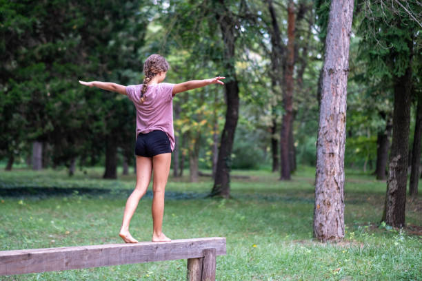 istock a little girl walks on a beam 1860391403