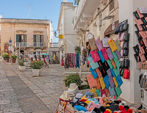 A  womens clothes shop in Ostuni, Italy, with a colourful display of clothing accessories.