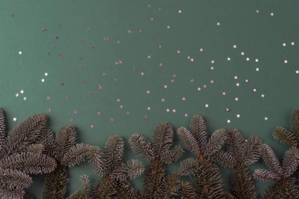 istock Christmas green background with fir branches and confetti. Top view, flat lay, copy space 1860394511