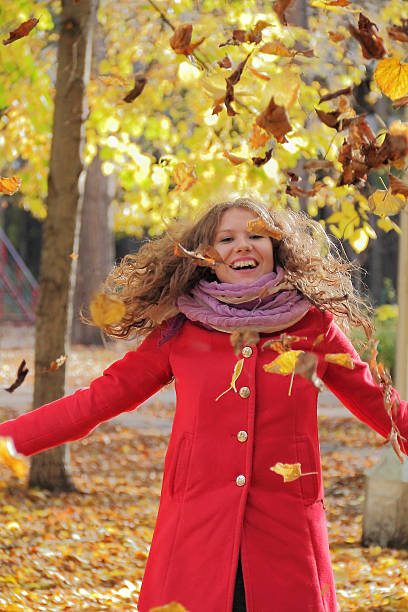 istock Young woman with autumn leaves 186041983
