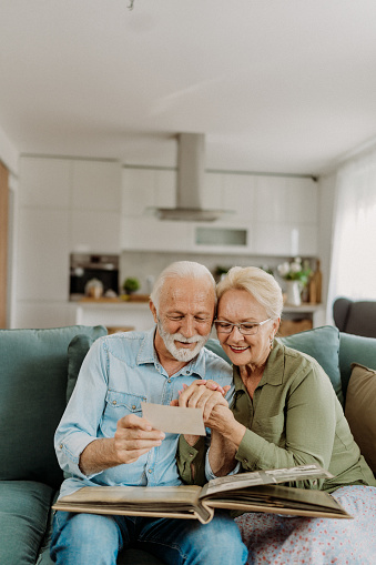 Senior couple looking at old photo album