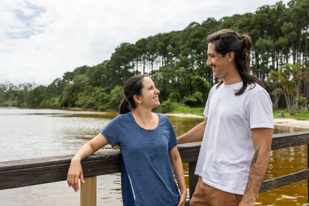 istock Happy Latin couple by a pond 1860438789