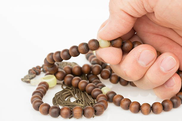 istock Prayer beads and rosary chanting. 186044167