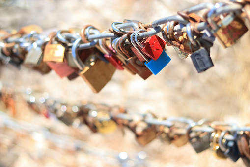 Makarska Croatia. Line of Love padlocks hanging on a chain. Love locks. Wedding locks. Symbol of eternal love. Valentine day. Colorful padlocks. Loyalty. Greeting card