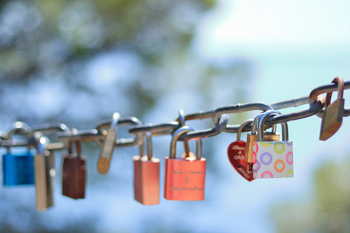 Makarska Croatia. Line of Love padlocks hanging on a chain. Love locks. Wedding locks. Symbol of eternal love. Valentine day. Colorful padlocks. Loyalty. Greeting card