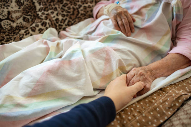 Family Member Holds Senior's Hand