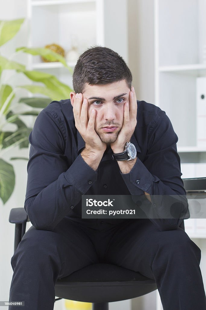 businessman sitting in a chair worried about job Senior businessman sitting in a chair worried about job Adult Stock Photo