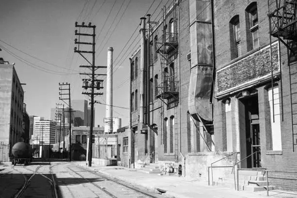 Archival 1985 black and white editorial view of Banning Street near Santa Fe Ave in downtown LA.  Brick warehouses in picture have been torn down.