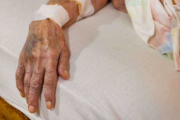 istock Sick Senior Woman Laying in Bed 1860460862