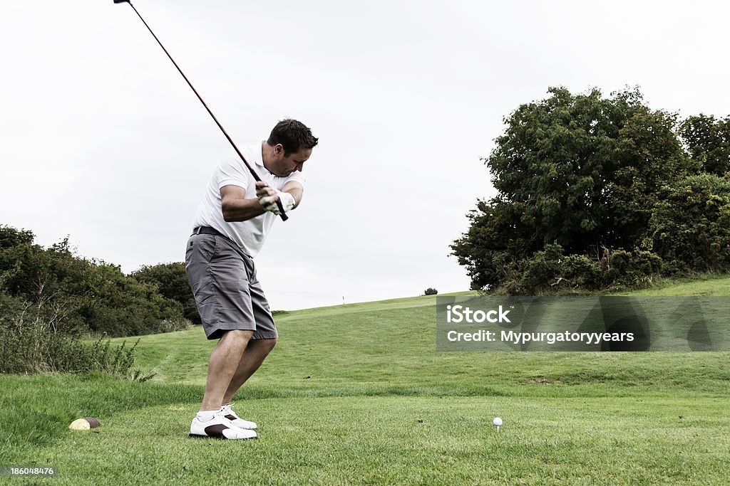 Driver A golfer just about to make his tee shot Adult Stock Photo