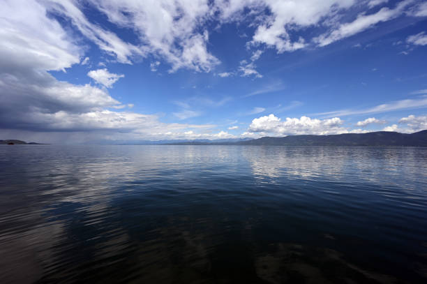 Beautiful dramatic summer cloudscape over Flathead Lake in Montana on calm June day.