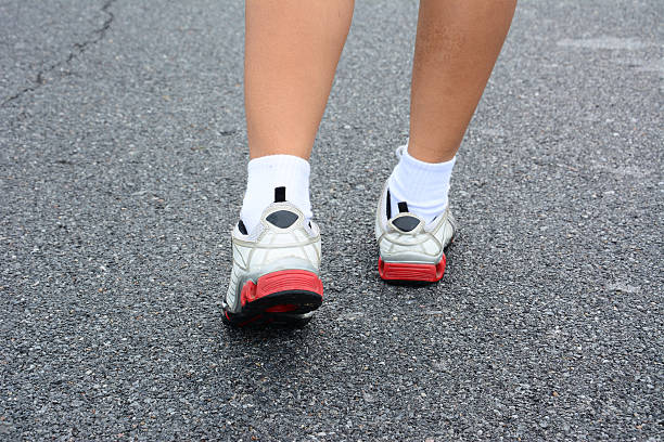 istock Runner feet running on road 186052669