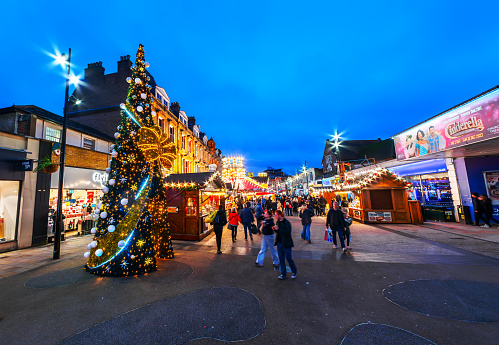 Bromley, Greater London, England - December 16, 2023: Bromley's High Street Extravaganza: A Captivating Christmas Market Showcase with Glittering Lights, Festive Decor, and Joyful Crowds