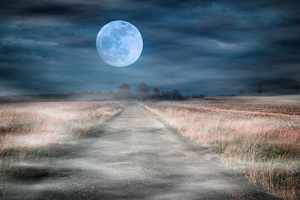 istock Moonrise over asphalt road 186058118