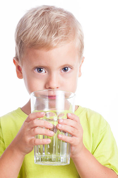 istock The boy drinks water from a glass 186062309