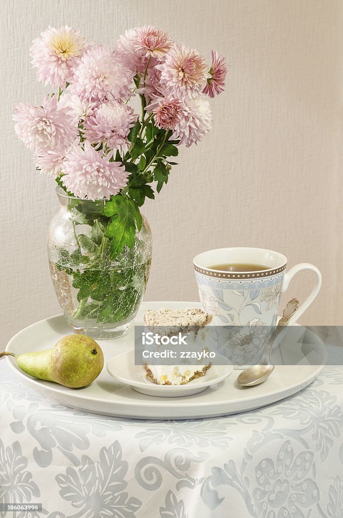 Ricotta and Pear Cake with cup of tea Ricotta and Pear Cake with cup of tea and bouquet of chrysanthemums. From the series "Italian desserts" Art Stock Photo