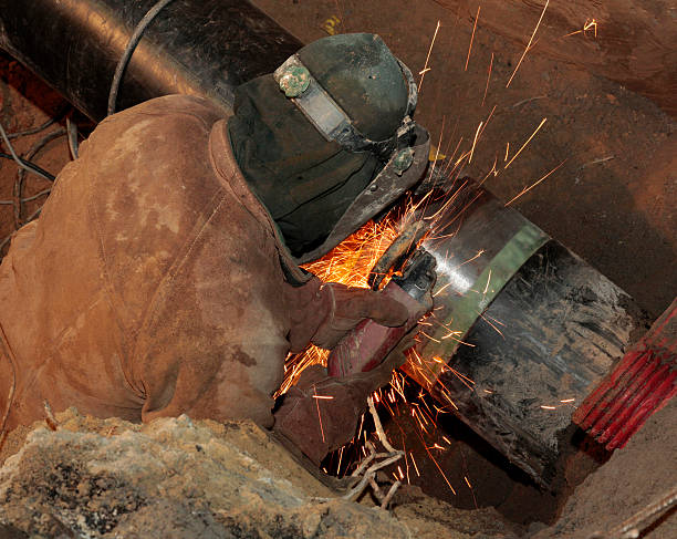 istock Welding gas pipe along street at night. 186065383