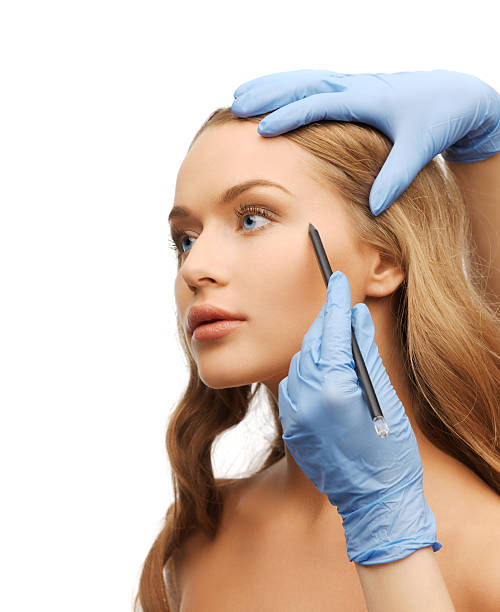 istock woman face and beautician hands with pencil 186065826