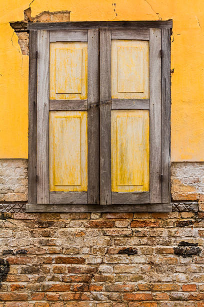 Wooden yellow window in  colonial building stock photo