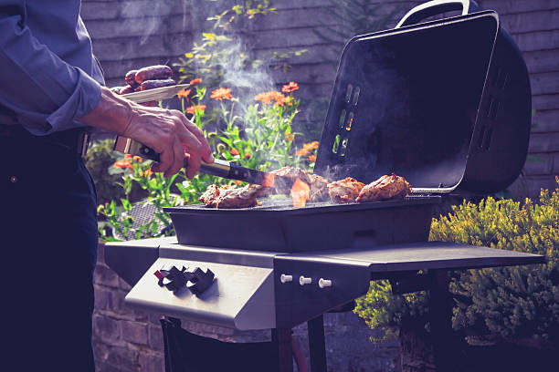 istock Senior man cooking meat on barbecue 186066562