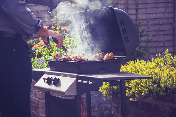 istock Man cooking meat on barbecue outdoors 186066587