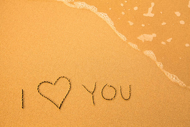 istock I Love You - text written by hand in sand 186066812