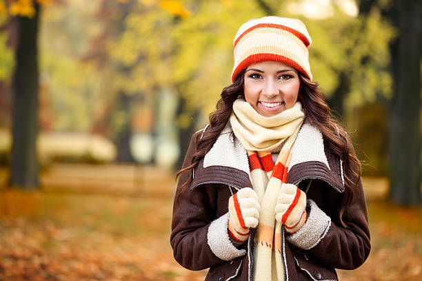 istock girl feeling cold in autumn park 186067565