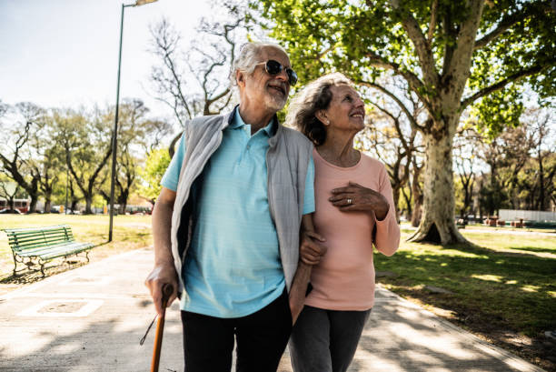 Happy elderly people walking in the park on a sunny day.