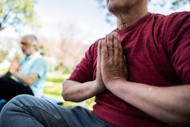 istock Senior man meditating in prayer pose outdoors 1860696151