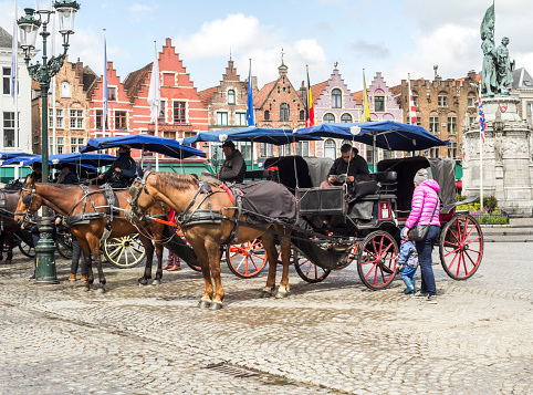 burges/Belgium- Oct 28 2019:crowd tourists walking in Grote Markt square and Belfort tower in Bruges, Belgium.