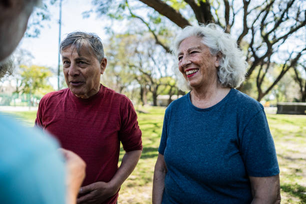 istock Senior friends talking on the public park 1860697208