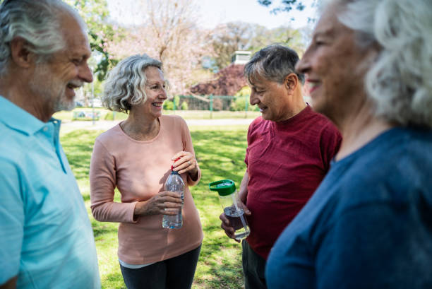 istock Senior friends talking on the public park 1860697719