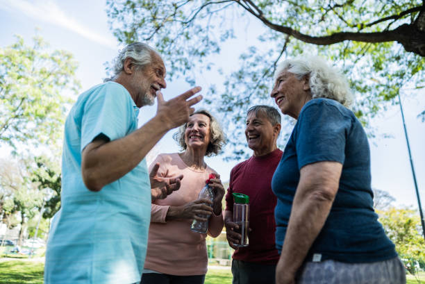 istock Senior friends talking on the public park 1860697728