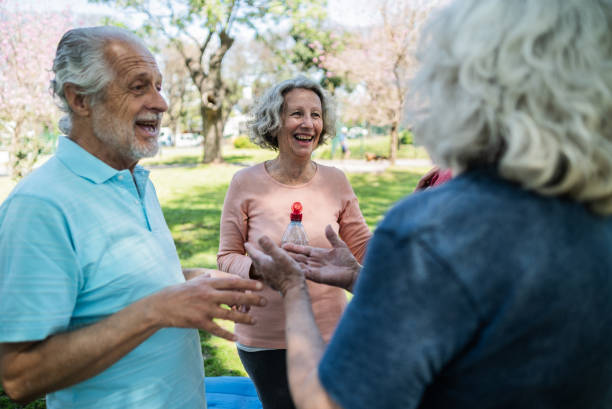 istock Senior friends talking on the public park 1860697732
