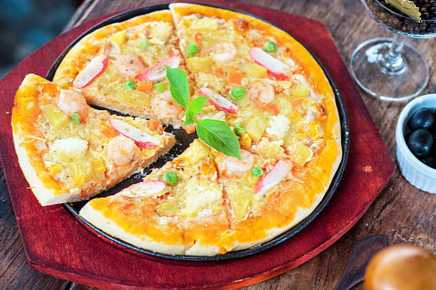 istock Fresh pizza on a wooden board 186071022