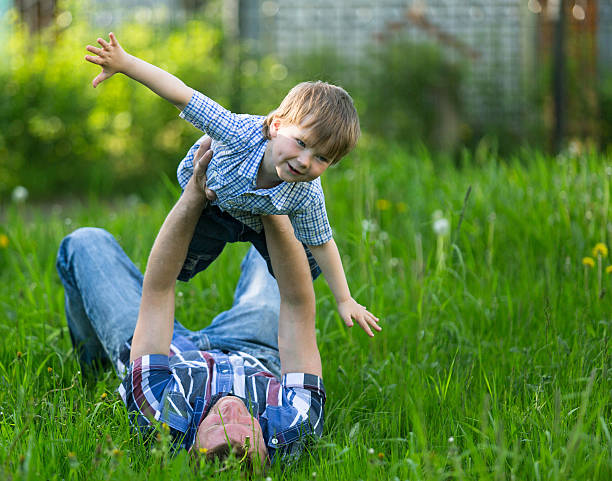 istock Father playing with his small son in the grass 186074524