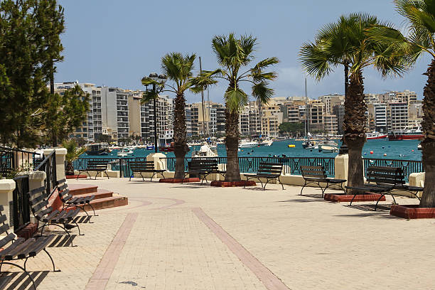 istock Walkway with park benches overlooking water in Sliema, Malta 186078493