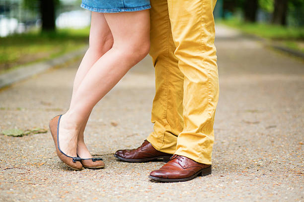 Male and female legs during a date Male and female legs during a date flat shoe stock pictures, royalty-free photos & images