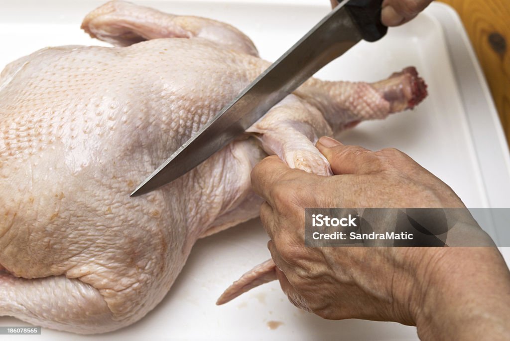 Raw chicken meat Hand with knife cutting chicken meat Adult Stock Photo