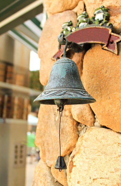 istock Antique bell hanging on stone wall 186080848