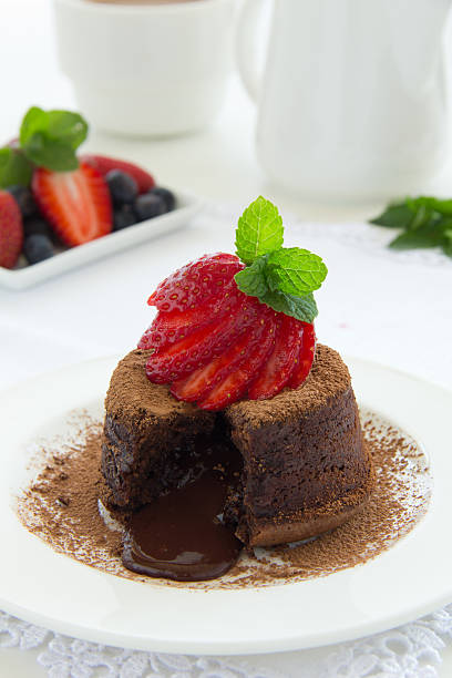 istock Chocolate dessert fondant with a liquid center and strawberries. 186081314