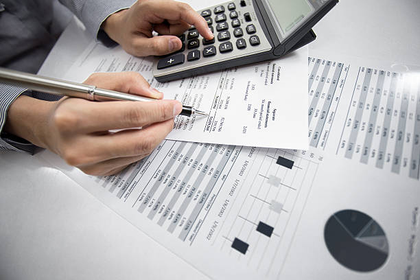 istock woman hand with business report 186081642
