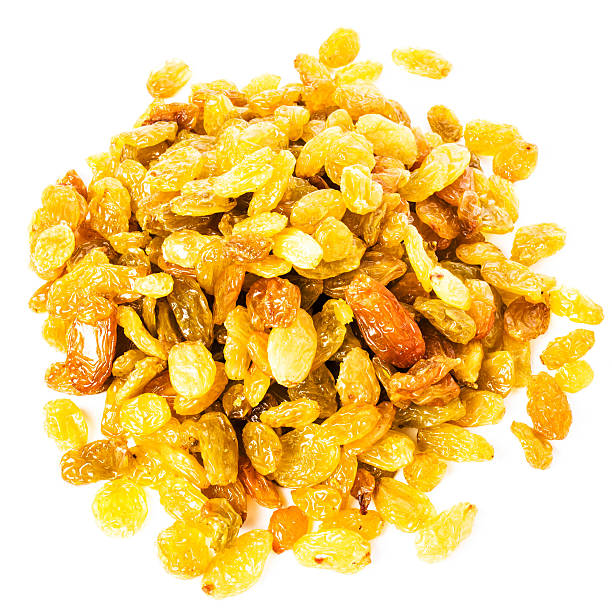 Heap of  Golden Shiny Raisins isolated on white background, clos