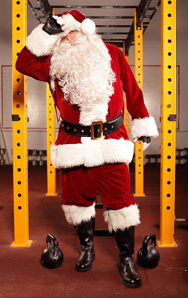 istock Sweating, tired Santa Claus having break in training 186082214