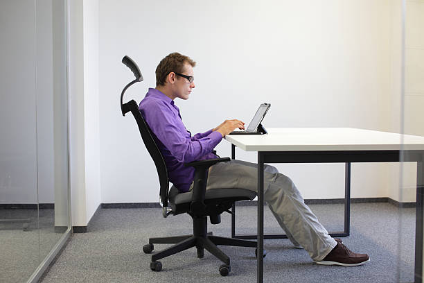 Sitting posture at tablet Sitting posture at tablet, tired business man on chair in his office ergonomic keyboard photos stock pictures, royalty-free photos & images